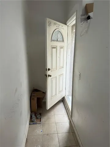 a view of the patio with table and chairs potted plants and large tree
