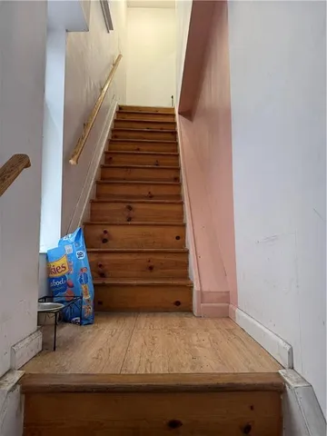 a backyard of a house with barbeque oven table and chairs