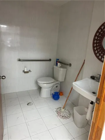 a bathroom with a toilet and a mirror