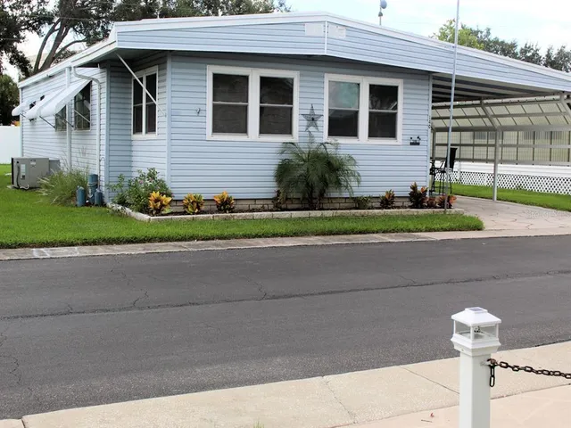 a front view of a house with a yard and outdoor seating