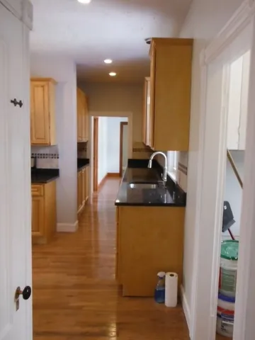 a kitchen with sink and refrigerator