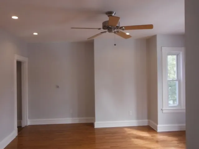 a white toilet sitting next to a bath tub