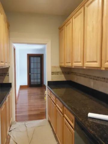 a close view of a refrigerator a sink and dishwasher in a kitchen