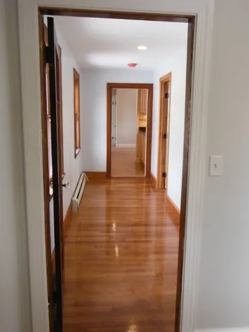 a view of hallway with wooden floor