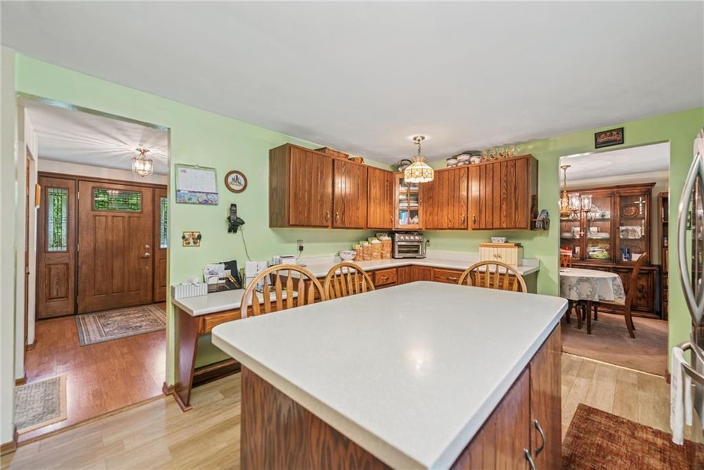 982 Braddock Road Pittsburgh, PA 15221 - Photo 11 of 32 a kitchen with stainless steel appliances granite countertop a table chairs sink and cabinets