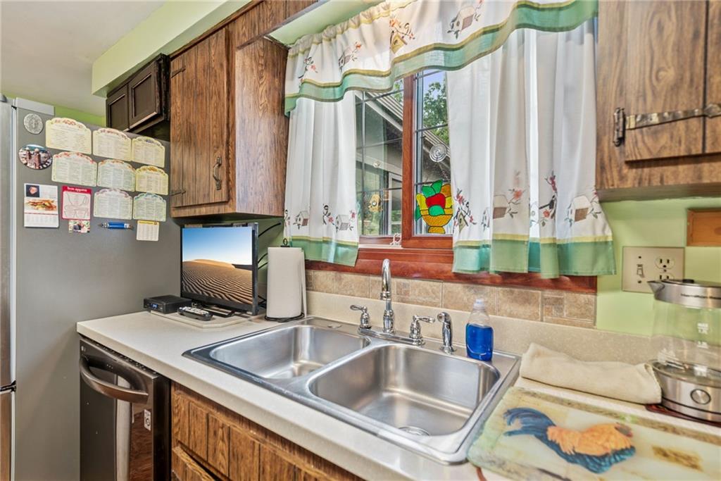982 Braddock Road Pittsburgh, PA 15221 - Photo 12 of 32 a kitchen with a sink and a refrigerator