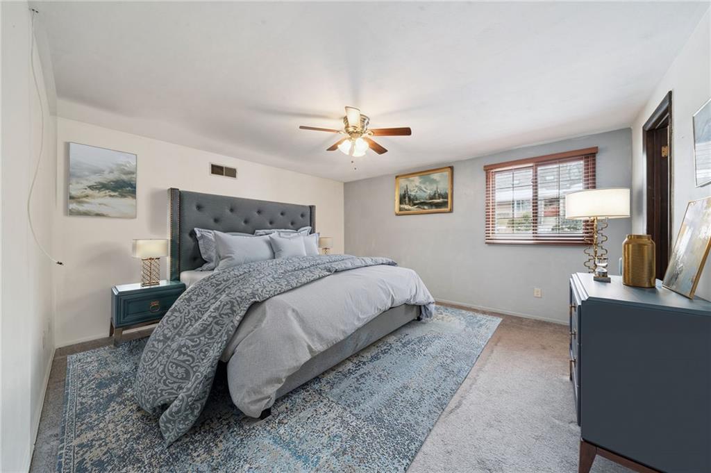 982 Braddock Road Pittsburgh, PA 15221 - Photo 20 of 32 a bedroom with a bed and a flat screen tv