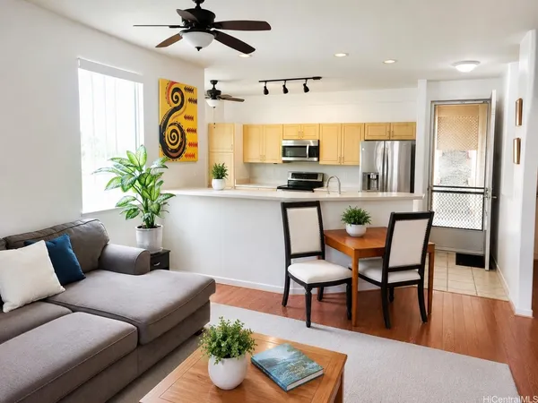 a living room with furniture and kitchen view