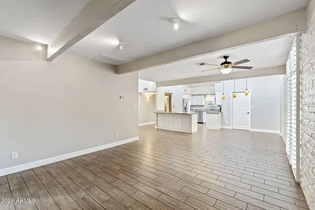 a view of an empty room with a fireplace and a window