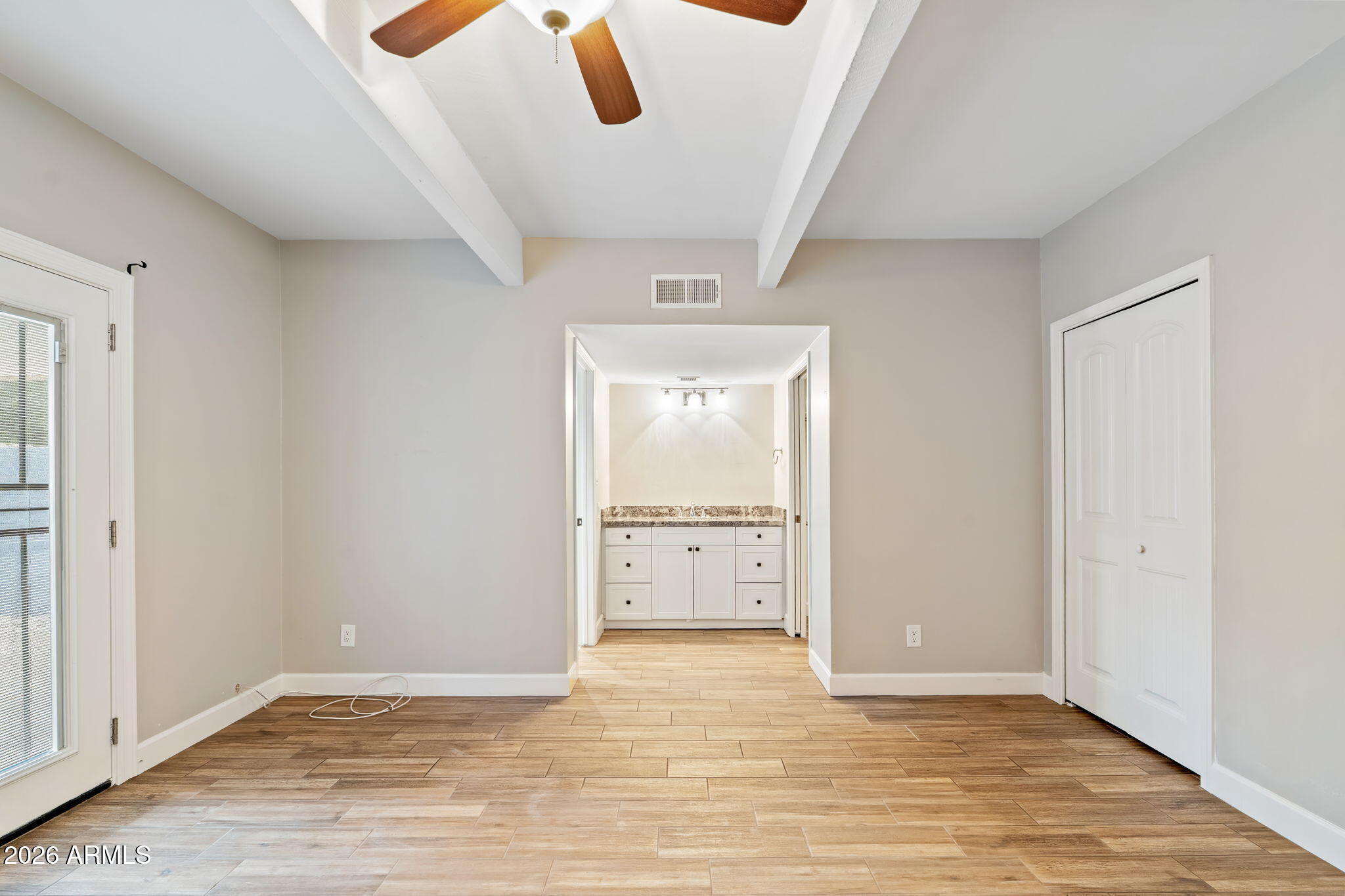 7840 North 7th Street, Unit 1 Phoenix, AZ 85020 - Photo 23 of 42 a view of an empty room with window and wooden floor