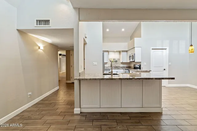 a kitchen with stainless steel appliances granite countertop a sink and cabinets