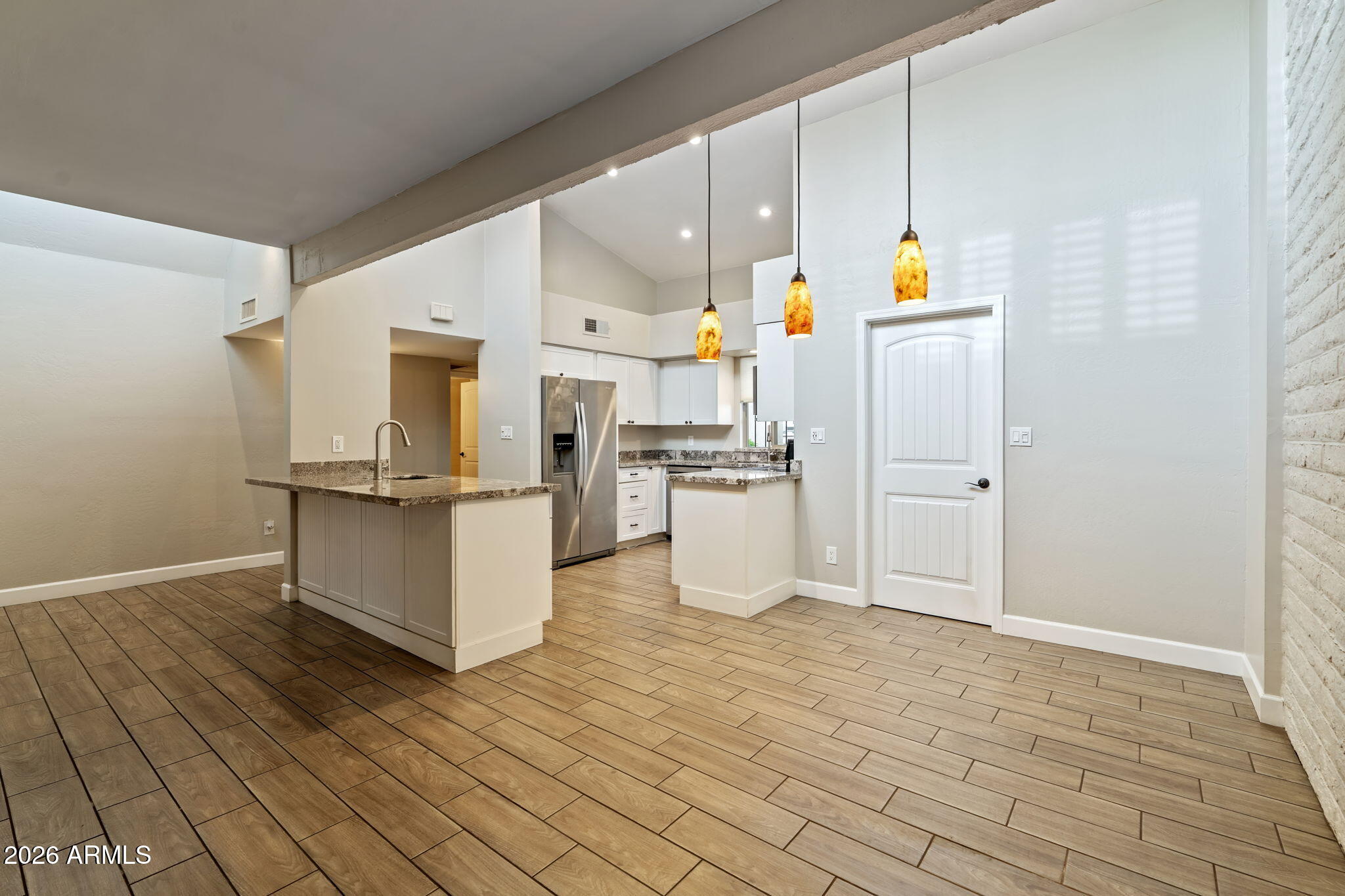 7840 North 7th Street, Unit 1 Phoenix, AZ 85020 - Photo 10 of 42 a kitchen with stainless steel appliances a refrigerator and white cabinets