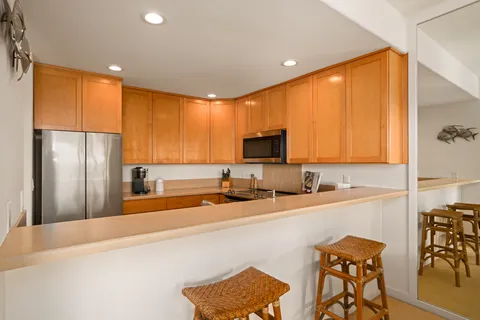 a kitchen with stainless steel appliances a microwave a sink and cabinets