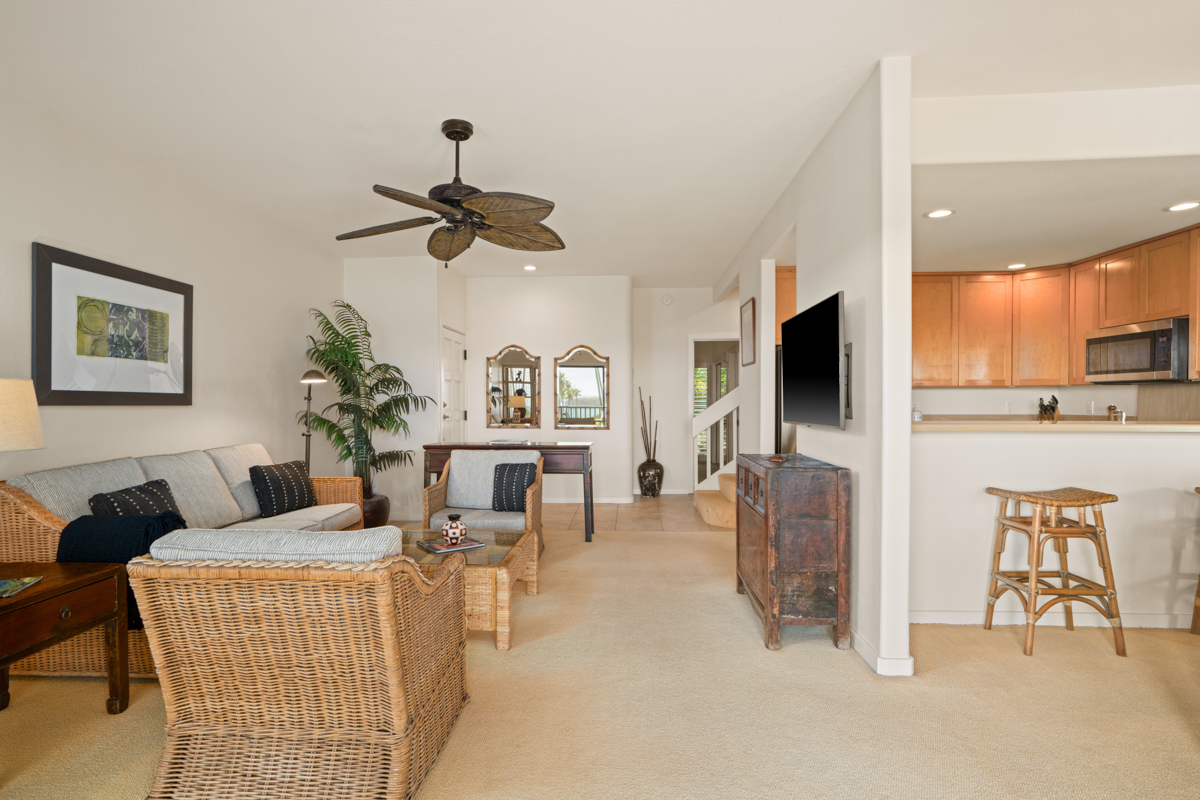 1565 Pe'e Road, Unit 125 Koloa, HI 96756 - Photo 9 of 19 a living room with furniture a flat screen tv and kitchen view