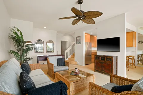 a living room with furniture a flat screen tv and a fireplace
