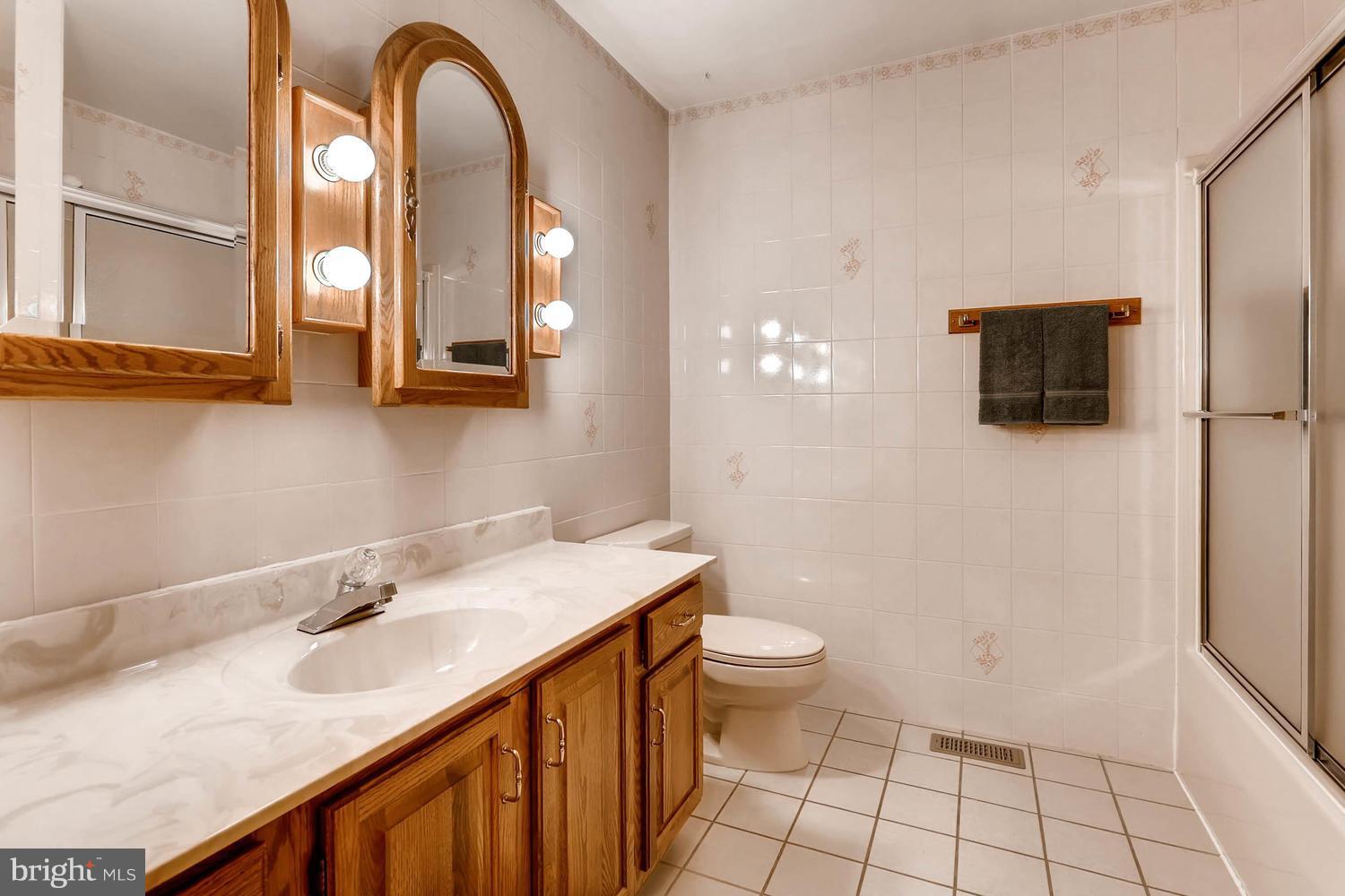 14000 Baldwin Mill Road Baldwin, MD 21013 - Photo 21 of 28 a bathroom with a sink a toilet and a mirror