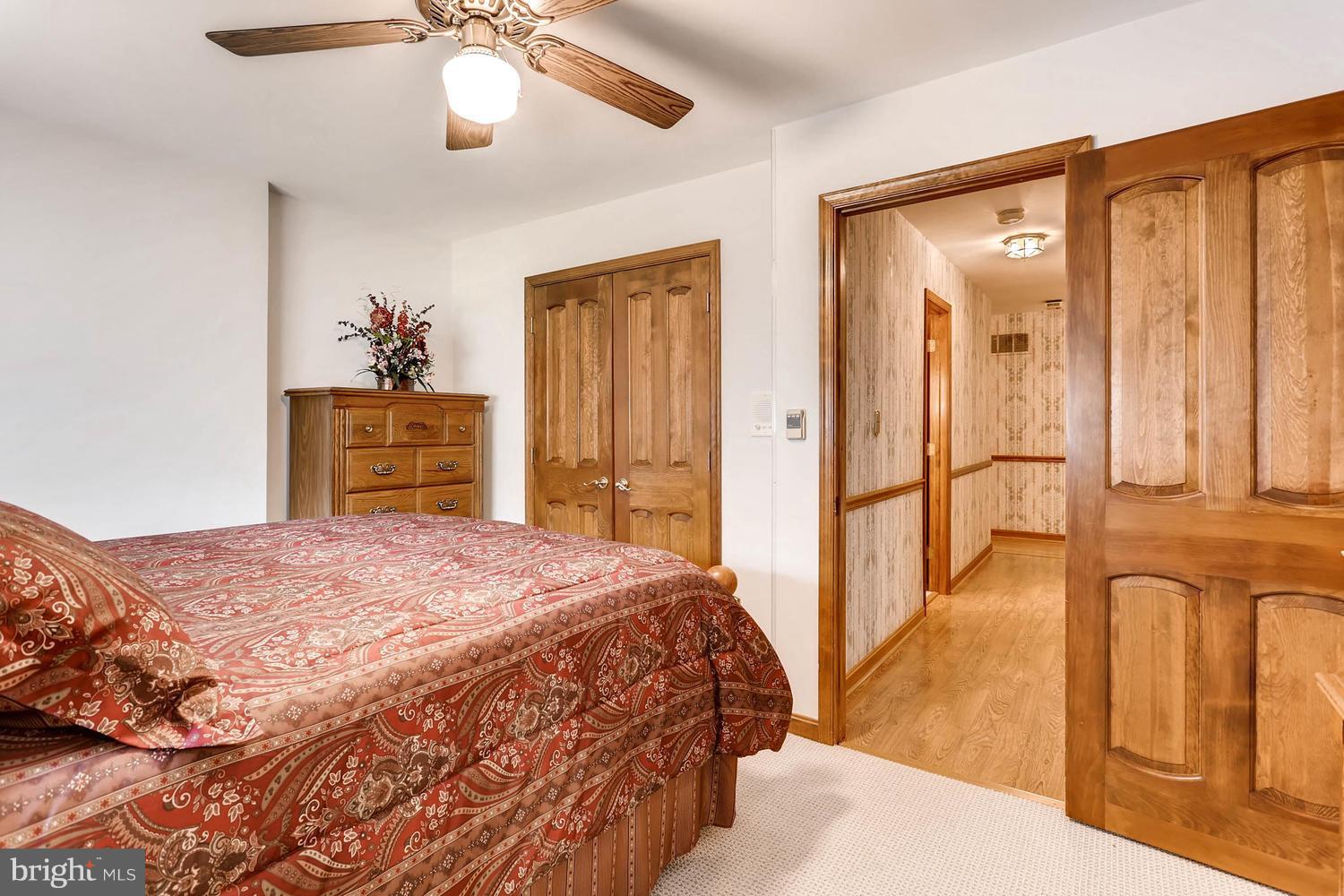 14000 Baldwin Mill Road Baldwin, MD 21013 - Photo 22 of 28 a bedroom with a bed and a chandelier