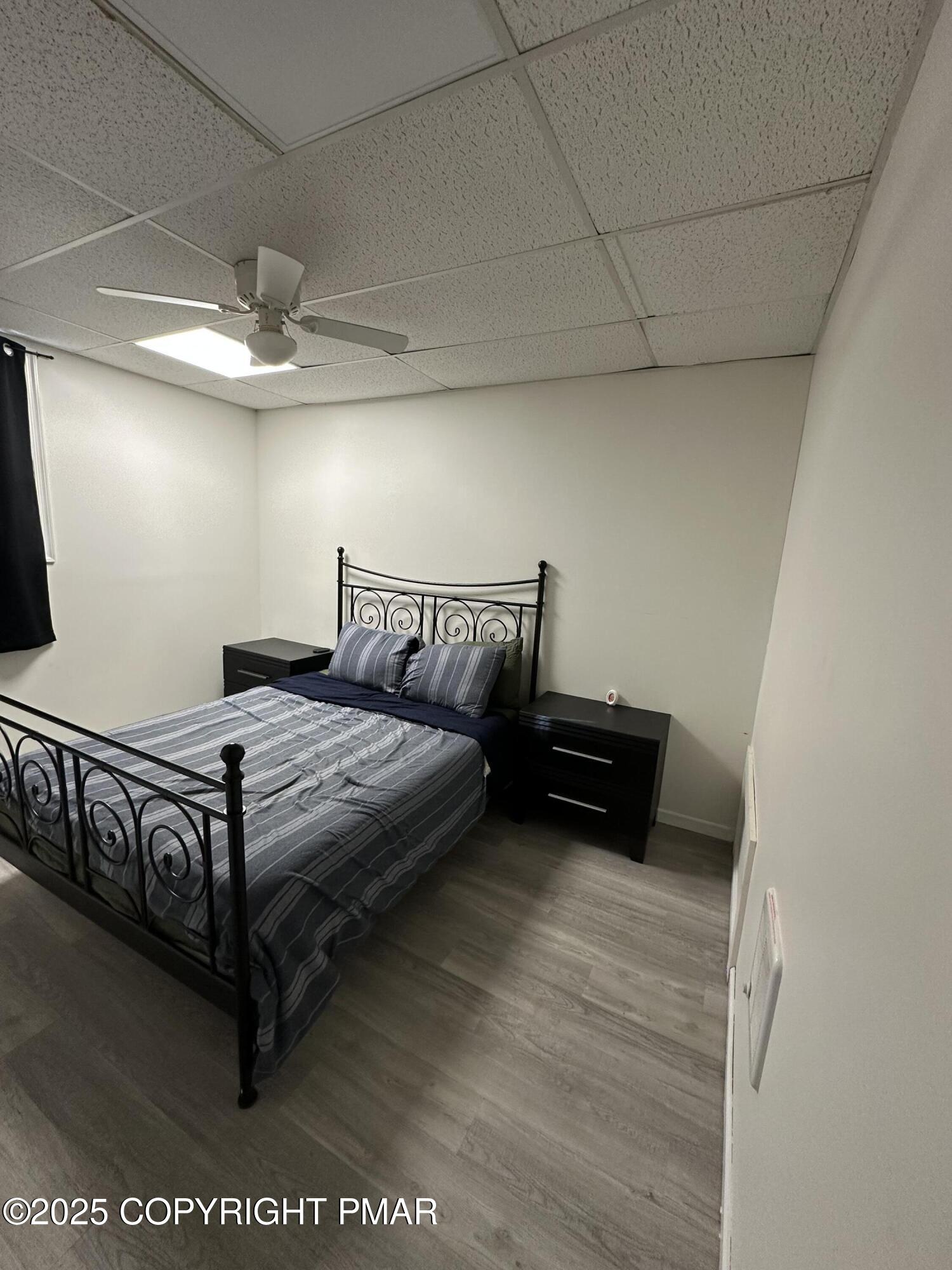 2656 Woodruff Lane, Unit B Stroudsburg, PA 18360 - Photo 6 of 8 a bedroom with a bed and window