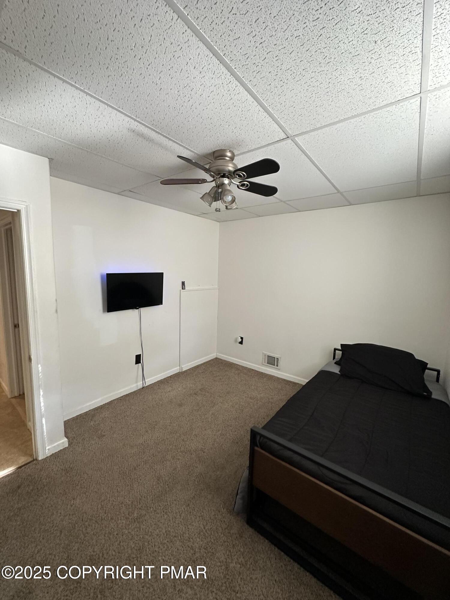 2656 Woodruff Lane, Unit B Stroudsburg, PA 18360 - Photo 7 of 8 a room with a table and a ceiling fan