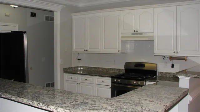 a kitchen with granite countertop white cabinets and a granite counter tops
