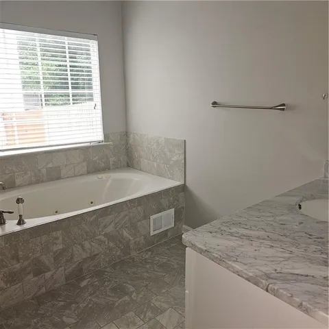 a bathroom with a bathtub and a shower