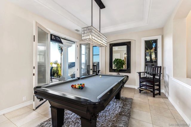 a room with pool table and windows