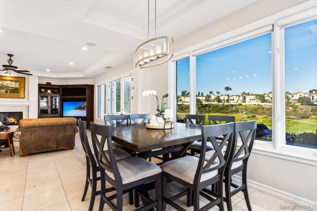 a view of a dining room with furniture one side kitchen view and wooden floor