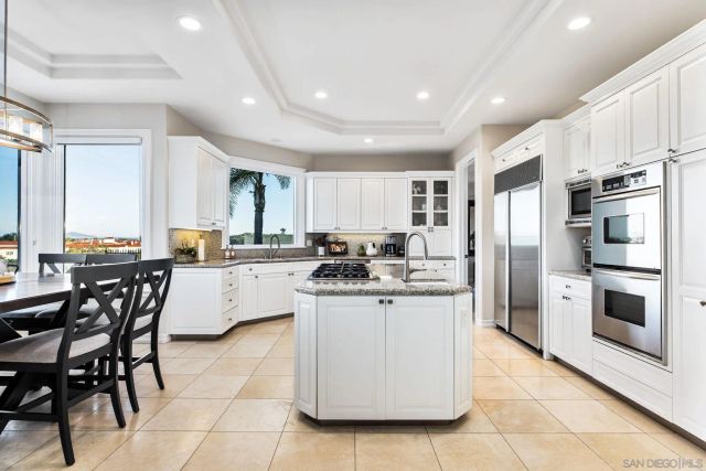 a kitchen with a sink window and cabinets