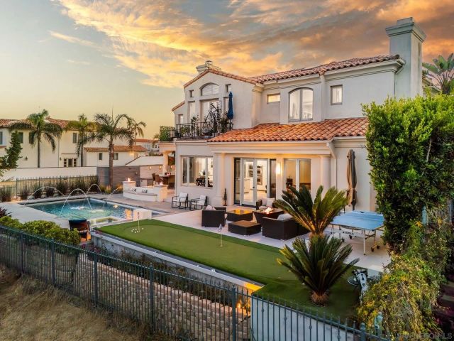 a front view of a house with garden and patio