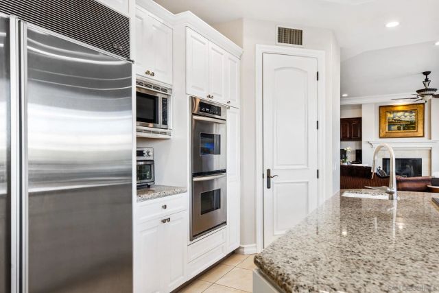a large kitchen with a table and chairs