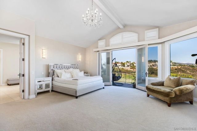 a spacious bedroom with a balcony a bed and a fireplace
