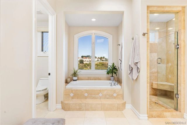 a bedroom with a large bed and a large window