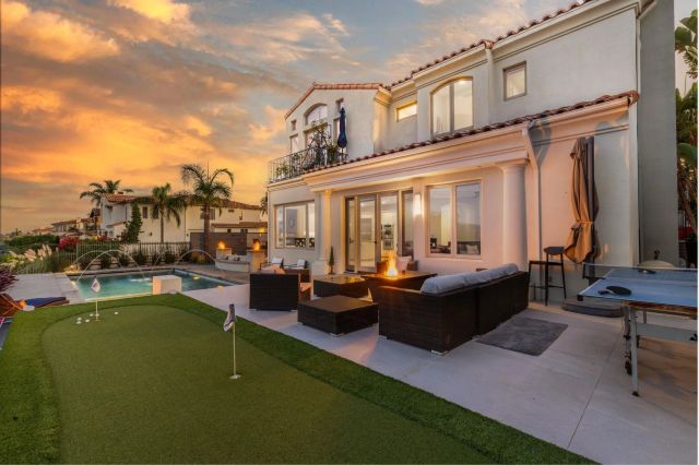 a view of a patio with couches table and chairs with potted plants