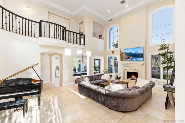 a living room with furniture a fireplace and a floor to ceiling window
