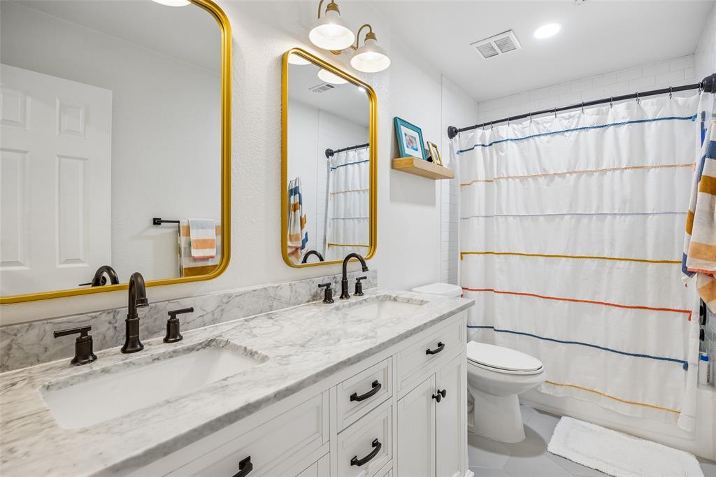 5511 South Briar Ridge Circle McKinney, TX 75072 - Photo 23 of 35 a bathroom with a granite countertop sink toilet and shower