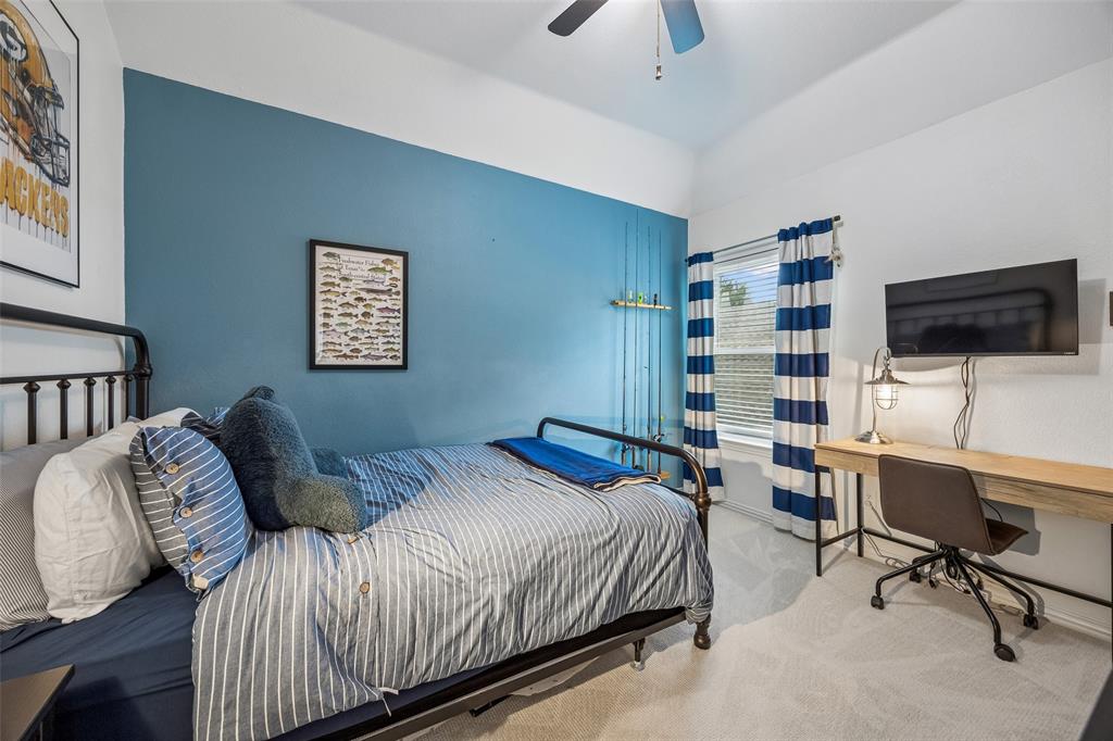 5511 South Briar Ridge Circle McKinney, TX 75072 - Photo 24 of 35 a bedroom with a bed and a flat screen tv