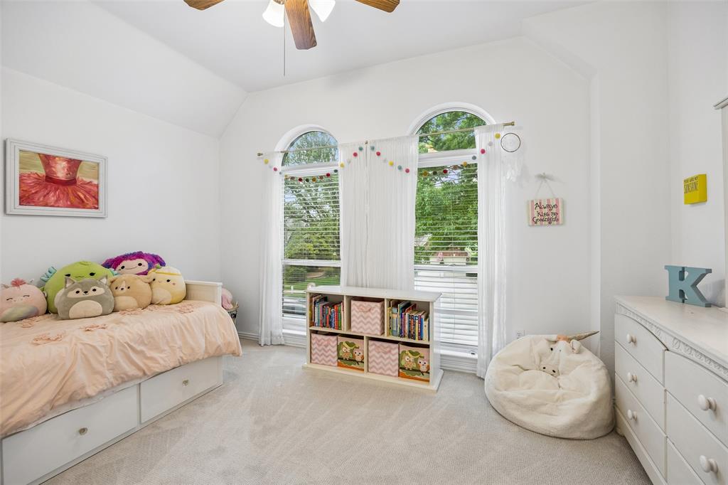 5511 South Briar Ridge Circle McKinney, TX 75072 - Photo 25 of 35 a bedroom with a bed and a large window