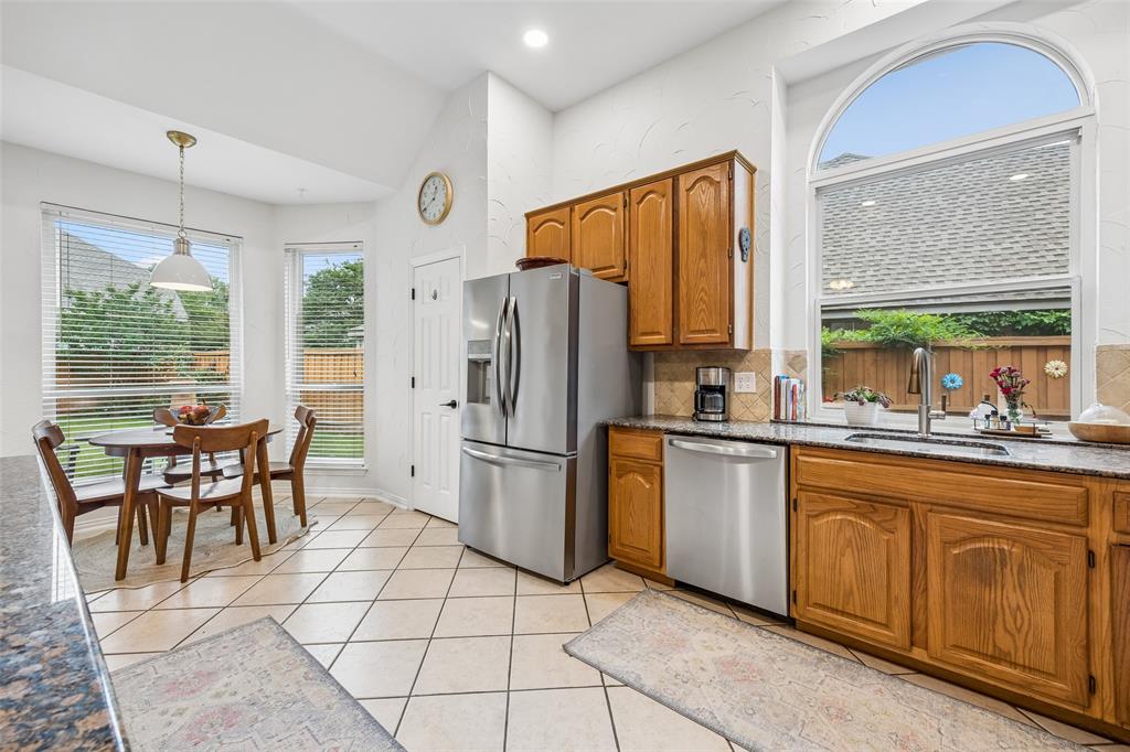 5511 South Briar Ridge Circle McKinney, TX 75072 - Photo 26 of 35 a kitchen with appliances cabinets and furniture
