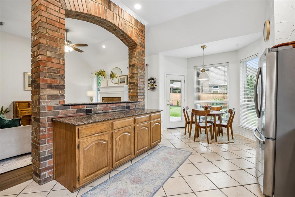 5511 South Briar Ridge Circle McKinney, TX 75072 - Photo 27 of 35 a dining hall with stainless steel appliances granite countertop a stove a sink a dining table and chairs