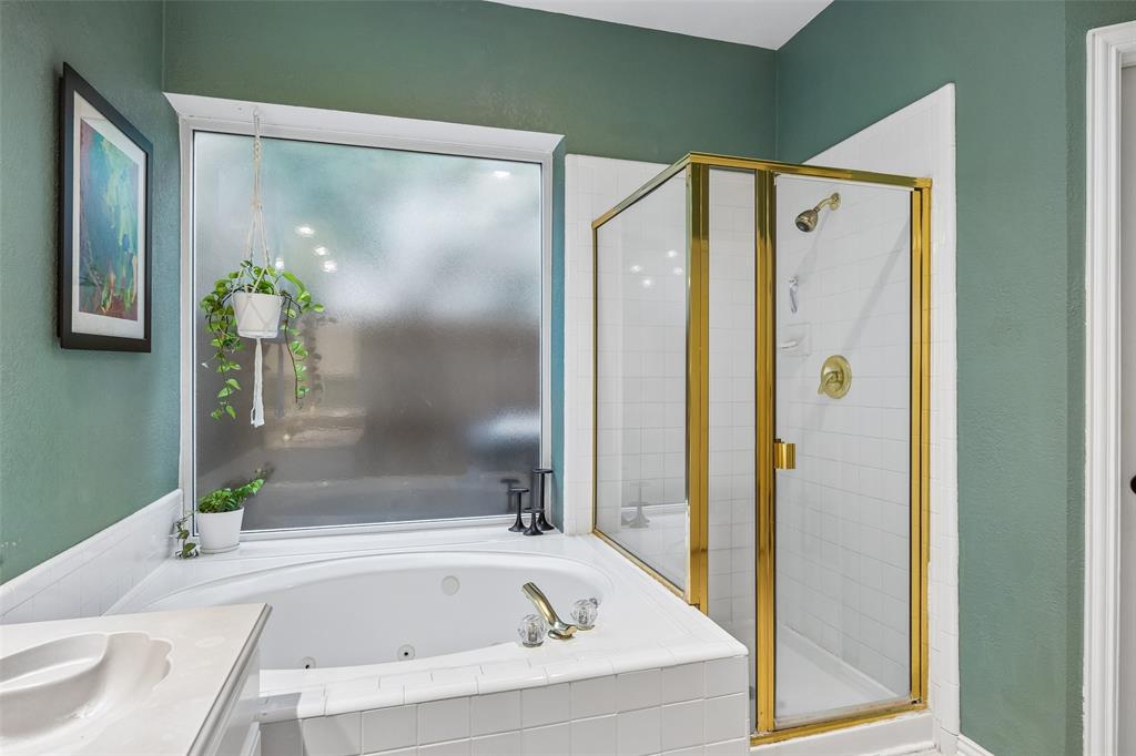 5511 South Briar Ridge Circle McKinney, TX 75072 - Photo 7 of 35 a bathroom with a bathtub and a shower