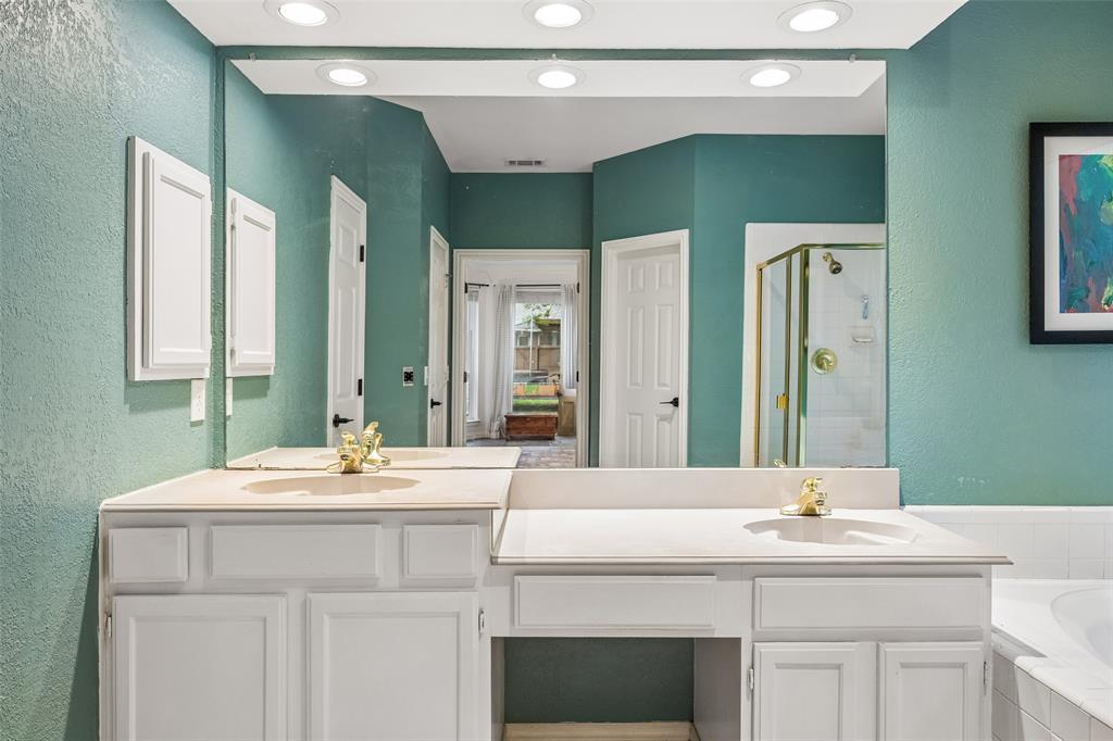 5511 South Briar Ridge Circle McKinney, TX 75072 - Photo 8 of 35 a bathroom with a sink and a mirror