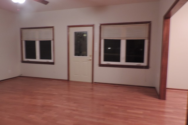 29448 Quigley Road Manhattan, IL 60442 - Photo 2 of 11 an empty room with wooden floor and windows