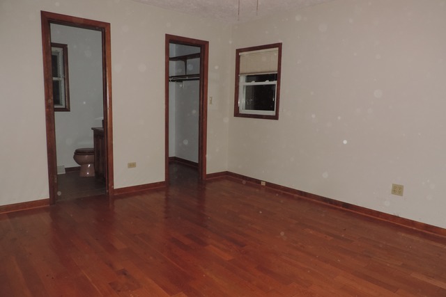29448 Quigley Road Manhattan, IL 60442 - Photo 3 of 11 an empty room with wooden floor and windows