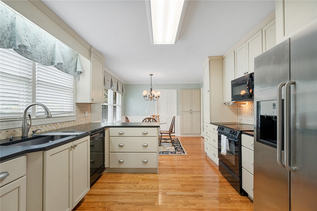 1211 Melbourne Drive Anderson, SC 29621 - Photo 12 of 35 This spacious kitchen offers ample counter space and connects seamlessly to a bright dining area.