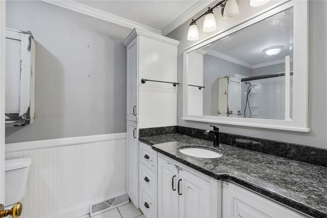 1211 Melbourne Drive Anderson, SC 29621 - Photo 25 of 35 This clean bathroom features a spacious vanity with elegant countertops and a convenient built-in cabinet.
