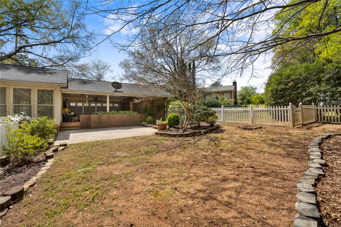 1211 Melbourne Drive Anderson, SC 29621 - Photo 31 of 35 This spacious backyard with a picket fence offers ample room for outdoor activities and gardening.