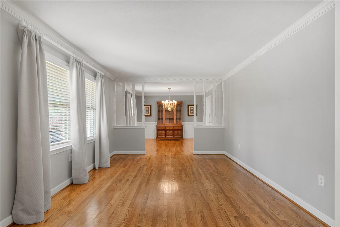 1211 Melbourne Drive Anderson, SC 29621 - Photo 4 of 35 This living area features polished hardwood floors and intricate crown molding.