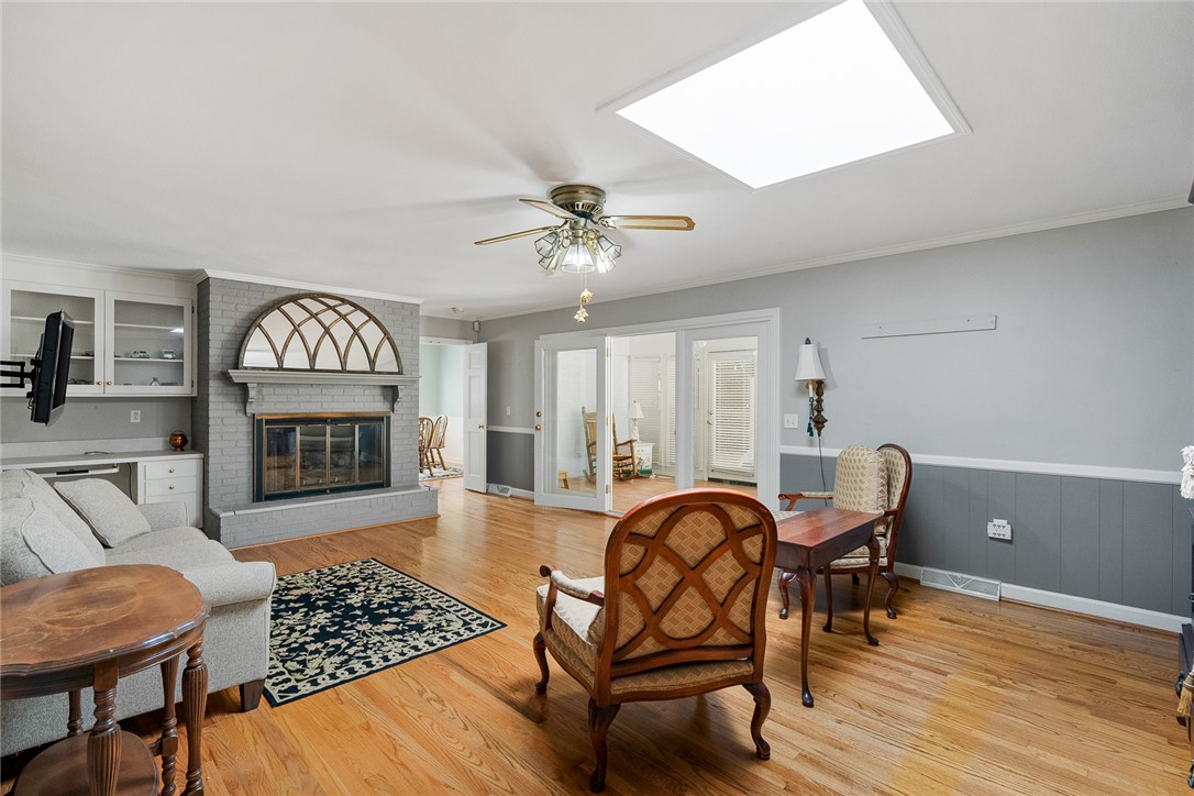 1211 Melbourne Drive Anderson, SC 29621 - Photo 9 of 35 This inviting living space features gleaming wood floors and a prominent fireplace, perfect for gatherings.