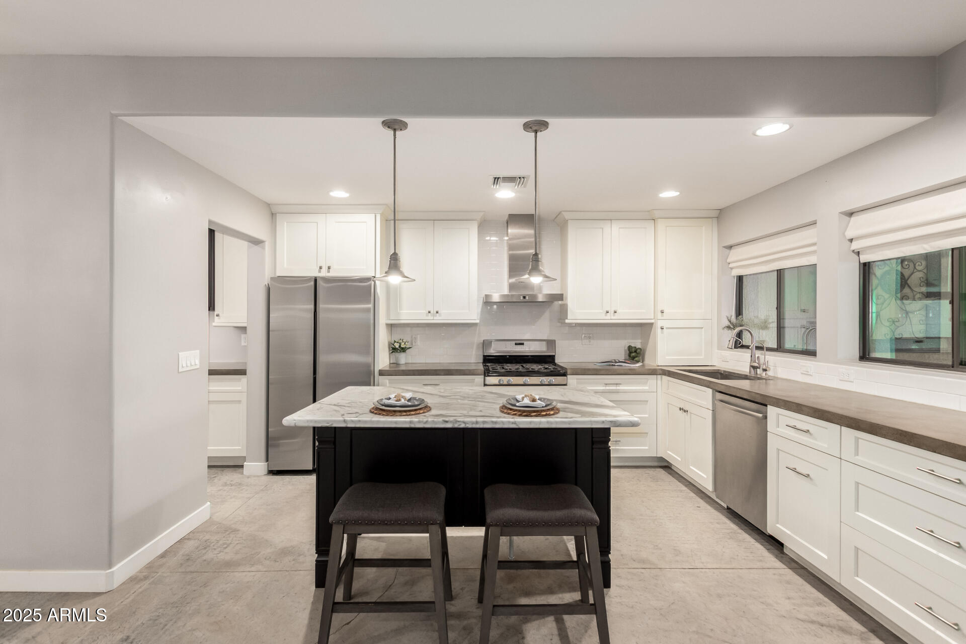 943 East Kortsen Road, Unit 10 Casa Grande, AZ 85122 - Photo 11 of 35 a kitchen with stainless steel appliances a table chairs refrigerator and cabinets