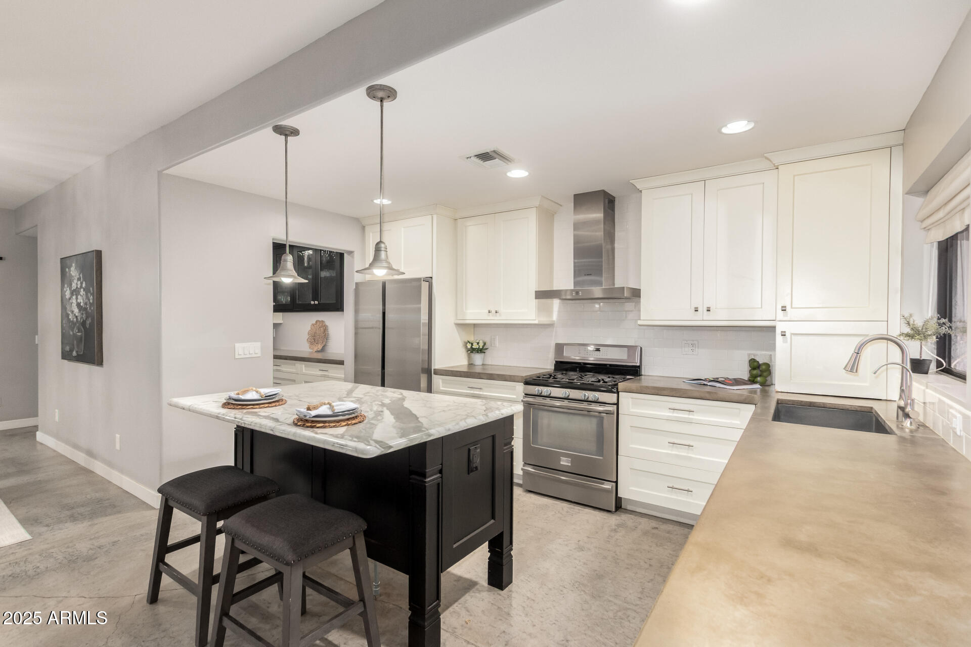 943 East Kortsen Road, Unit 10 Casa Grande, AZ 85122 - Photo 12 of 35 a kitchen with stainless steel appliances kitchen island granite countertop a sink a stove a refrigerator and island with wooden floor